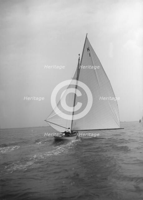 The 7 Metre 'Marsinah' (K1) sailing with spinnaker, 1912. Creator: Kirk & Sons of Cowes.