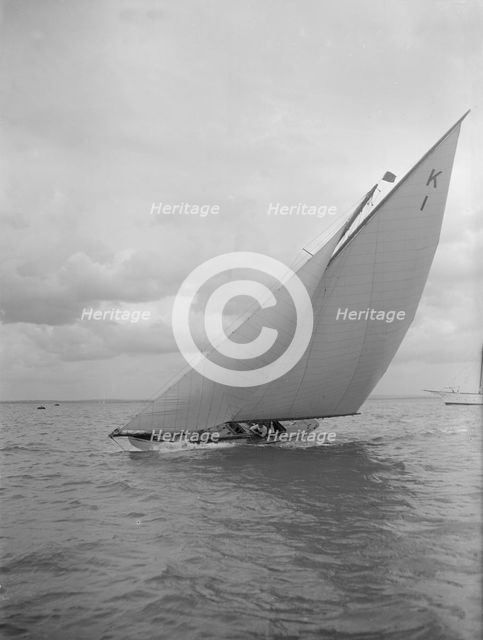 The 7 Metre 'Marsinah' (K1) sailing close-hauled, 1912. Creator: Kirk & Sons of Cowes.