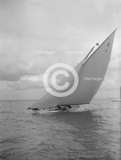 The 7 Metre 'Marsinah' (K1) sailing close-hauled, 1912. Creator: Kirk & Sons of Cowes.