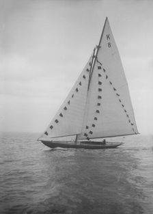 The 7 Metre sailing yacht Pinaster (K8) with prize flags, 1912. Creator: Kirk & Sons of Cowes