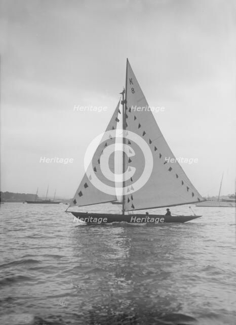 The 7 Metre sailing yacht 'Pinaster' (K8) with prize flags, 1912. Creator: Kirk & Sons of Cowes.