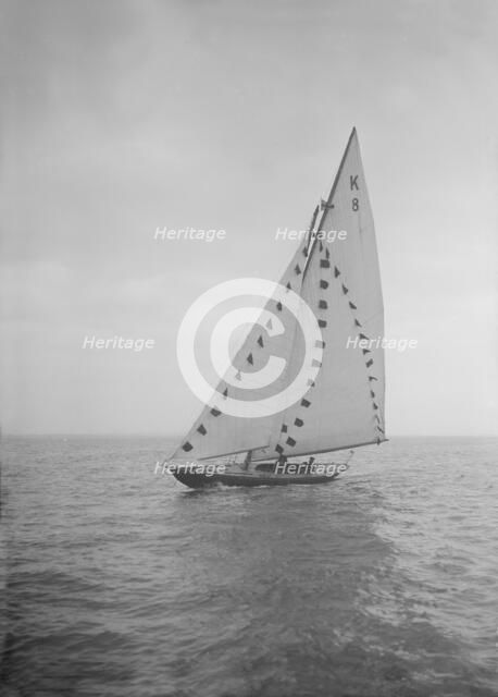 The 7 Metre sailing yacht 'Pinaster' (K8) with prize flags, 1912. Creator: Kirk & Sons of Cowes.