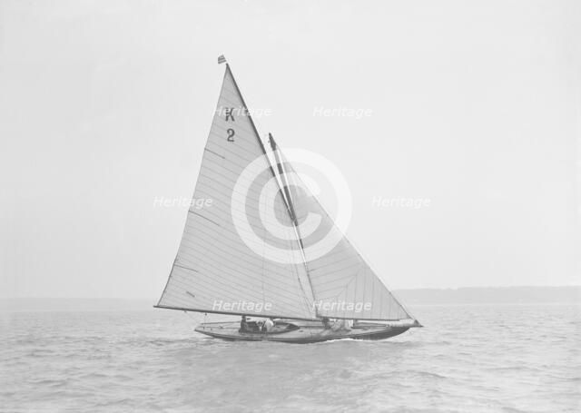 The 7 Metre yacht 'Ithnan' (K2) sailing close-hauled, 1911. Creator: Kirk & Sons of Cowes.