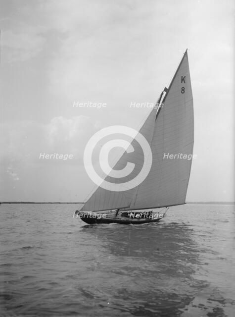 The 7 Metre yacht 'Pinaster' (K8) sailing with spinnaker, 1912. Creator: Kirk & Sons of Cowes.