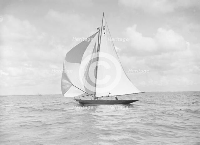 The 7 Metre yacht 'Pinaster' (K8) sailing with spinnaker, 1912. Creator: Kirk & Sons of Cowes.