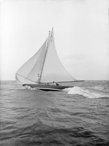 The 7 Metre yacht Pinaster (K8) sailing with spinnaker, 1913. Creator: Kirk & Sons of Cowes