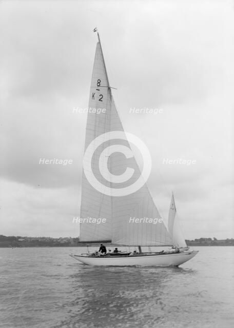 The 8 Metre Carron (K2) sailing upwind, 1934. Creator: Kirk & Sons of Cowes.
