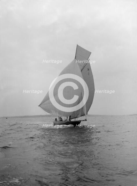 The 8 Metre class 'Antwerpia IV' sailing under spinnaker, 1912. Creator: Kirk & Sons of Cowes.
