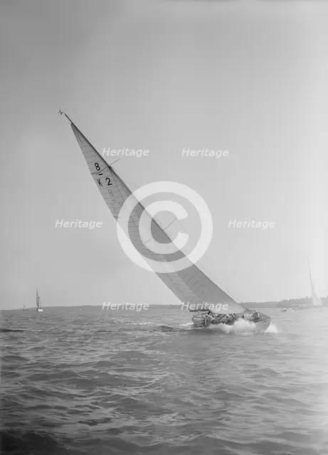 The 8 Metre class sailing yacht 'Carron' (K2), heeling upwind in a good breeze, 1934. Creator: Kirk & Sons of Cowes.