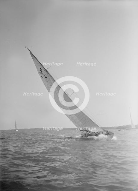 The 8 Metre class sailing yacht 'Carron' (K2), heeling upwind in a good breeze, 1934. Creator: Kirk & Sons of Cowes.