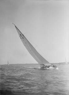The 8 Metre class sailing yacht Carron (K2), heeling upwind in a good breeze, 1934. Creator: Kirk & Sons of Cowes