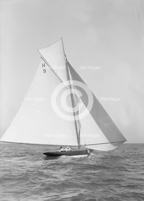 The 8 Metre class 'Termagent' (H9) sailing with spinnaker, 1911. Creator: Kirk & Sons of Cowes.