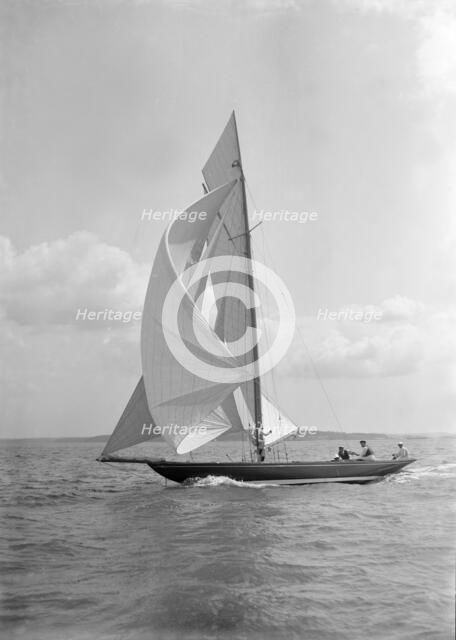 The 8 Metre 'Endrick' sailing downwind under spinnaker, 1911. Creator: Kirk & Sons of Cowes.