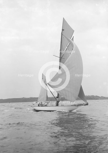 The 8-metre 'Ierne' sailing with spinnaker, 1913. Creator: Kirk & Sons of Cowes.