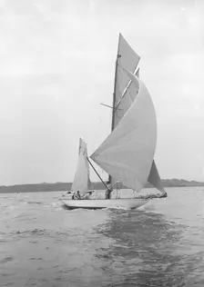 The 8-metre Ierne sailing with spinnaker, 1913. Creator: Kirk & Sons of Cowes