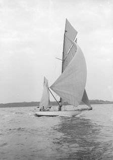 The 8-metre Ierne sailing with spinnaker, 1913. Creator: Kirk & Sons of Cowes