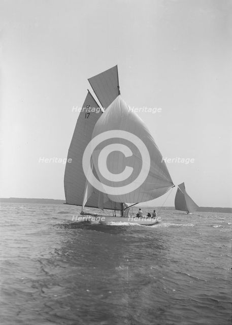 The 8 Metre 'Ierne' running down wind under spinnaker, 1913. Creator: Kirk & Sons of Cowes.