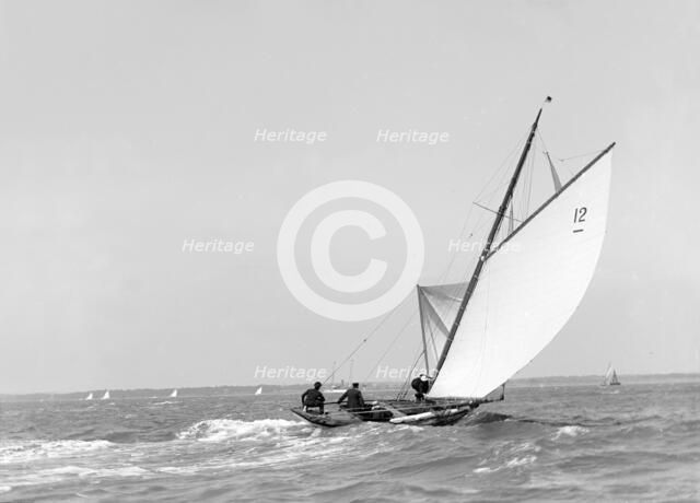 The 8 Metre sailing yacht 'Dilkusha' setting spinnaker, 1911. Creator: Kirk & Sons of Cowes.