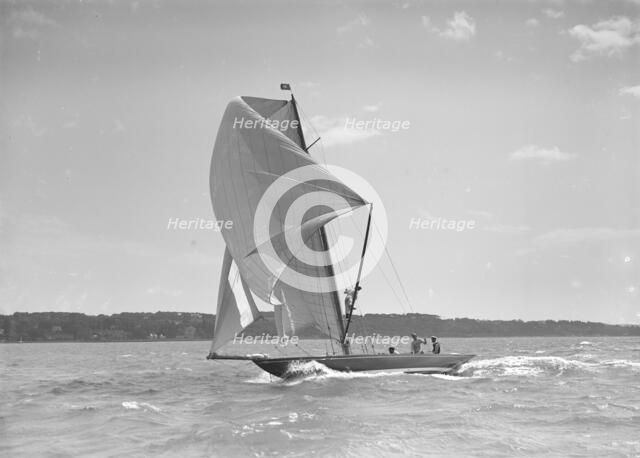 The 8 Metre sailing yacht 'Endrick' sailing downwind under spinnaker, 1911. Creator: Kirk & Sons of Cowes.