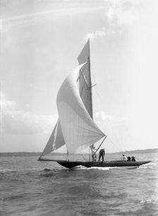The 8 Metre Termagant sailing with spinnaker, 1911. Creator: Kirk & Sons of Cowes