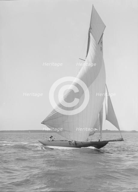 The 8 Metre 'Termagent' (H9) sailing downwind in fine weather, 1911. Creator: Kirk & Sons of Cowes.
