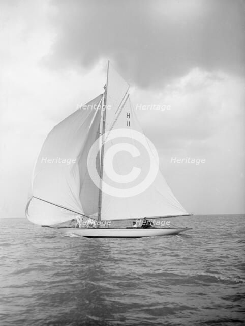 The 8 Metre 'Ventana' (H11) sailing with spinnaker, 1912. Creator: Kirk & Sons of Cowes.