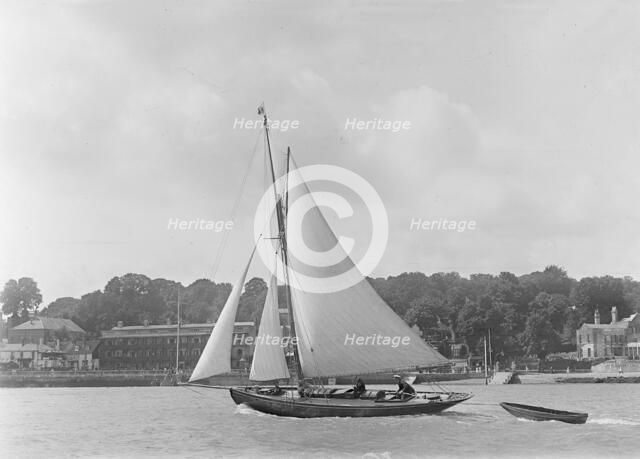 The 9 ton auxilary cutter 'Grayling' with  tender, 1921. Creator: Kirk & Sons of Cowes.