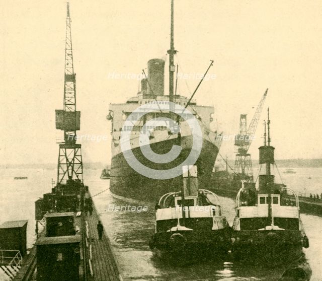 'The "Majestic" Entering Dry Dock Hauled by Tugs', c1930. Creator: Unknown.
