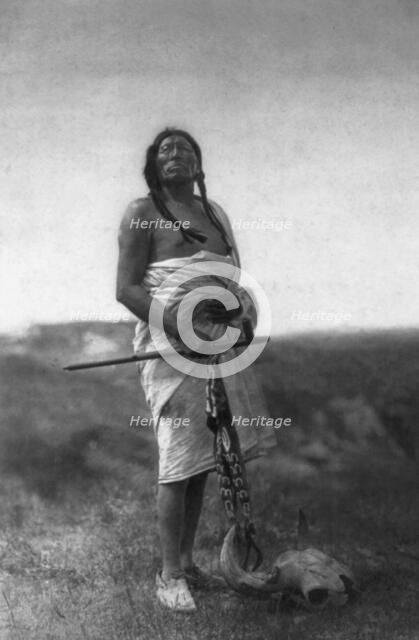 The Medicine Man (Slow Bull), c1907. Creator: Edward Sheriff Curtis.
