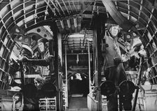 The midship gunners of an RAF flying boat alert at their stations, c1940 (1943)