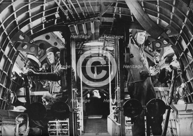 The midship gunners of an RAF flying boat alert at their stations, c1940 (1943). Artist: Unknown.