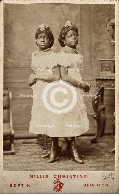 The Millie-Christine sisters, conjoined twins, standing, 1874. Creator: Bertin.