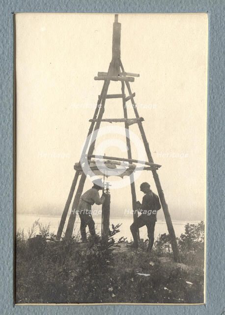 The moment of carrying out triangulation measurements under a tower on the river bank, 1909. Creator: Vladimir Ivanovich Fedorov.