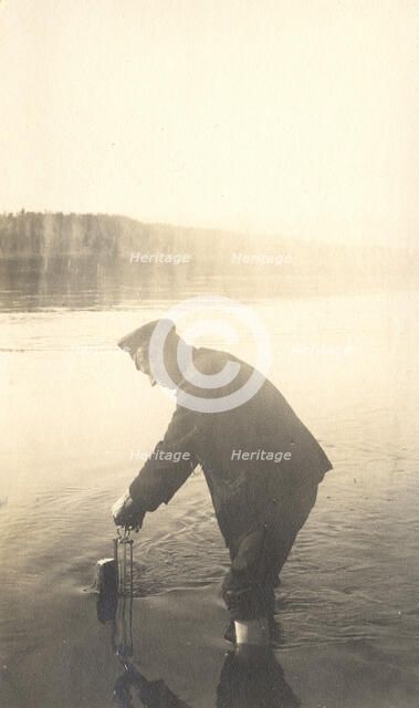 The moment of measuring the water level at the Inorogda hydrometric station, 1909. Creator: Vladimir Ivanovich Fedorov.