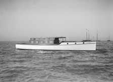 The motor launch Cygnet under way, 1912. Creator: Kirk & Sons of Cowes