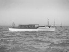 The motor launch Cygnet under way, 1912. Creator: Kirk & Sons of Cowes