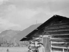The mother, father, and hardworking fifteen-year-old son in yard..., Boundary County, Idaho, 1939. Creator: Dorothea Lange