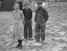 The mother, father, and hardworking fifteen-year-old son in yard..., Boundary County, Idaho, 1939. Creator: Dorothea Lange