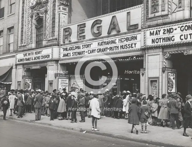 The movies are popular in the Negro section of Chicago, Illinois, April 1941. Creators: Farm Security Administration, Russell Lee.