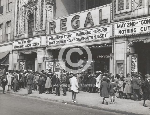 The movies are popular in the Negro section of Chicago, Illinois, April 1941. Creators: Farm Security Administration, Russell Lee.