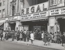 The movies are popular in the Negro section of Chicago, Illinois, April 1941. Creators: Farm Security Administration, Russell Lee