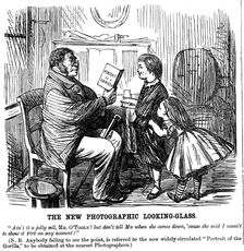 The New Photographic Looking Glass cartoon from Punch, everyday proof of man's origins, 1861