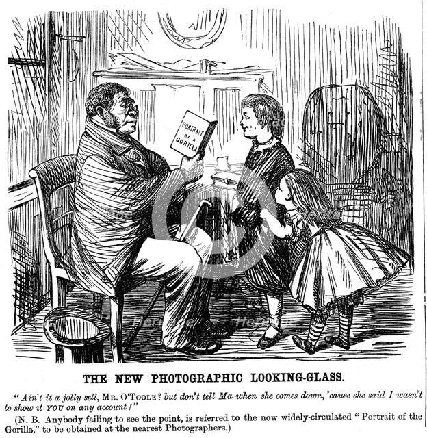 'The New Photographic Looking Glass', cartoon from Punch, everyday proof of man's origins, 1861. Artist: Unknown