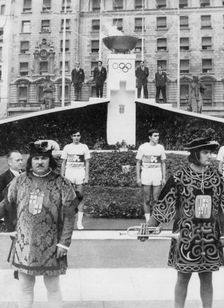 The Olympic flame outside the Catalonia Palace, Barcelona, Spain. Creator: Unknown