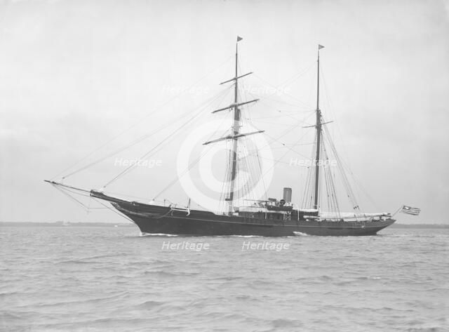 The auxiliary schooner 'Xarifa' at anchor, 1912. Creator: Kirk & Sons of Cowes.