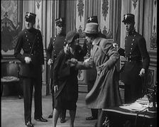 The Actor Gene Gerrard Hand Cuffed to His Co Star Being Watched By French Police They..., 1920s. Creator: British Pathe Ltd