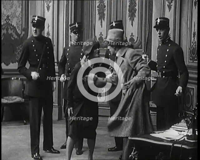 The Actor Gene Gerrard Hand Cuffed to His Co Star Being Watched By French Police They..., 1920s. Creator: British Pathe Ltd.