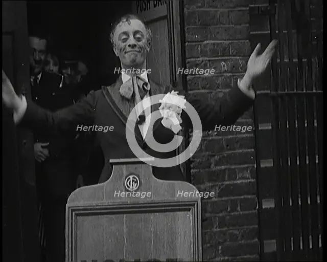 The Actor Leslie Henson Rising Spookily up from Behind a Mock Gravestone, 1920s. Creator: British Pathe Ltd.