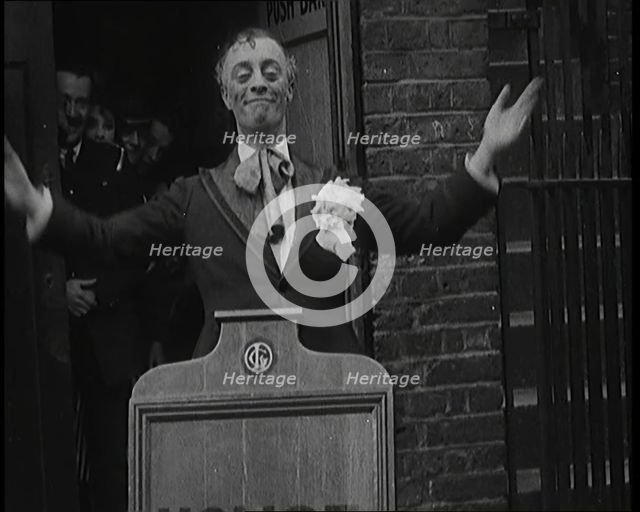The Actor Leslie Henson Rising Spookily up from Behind a Mock Gravestone, 1920s. Creator: British Pathe Ltd.