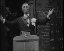 The Actor Leslie Henson Rising Spookily up from Behind a Mock Gravestone, 1920s. Creator: British Pathe Ltd